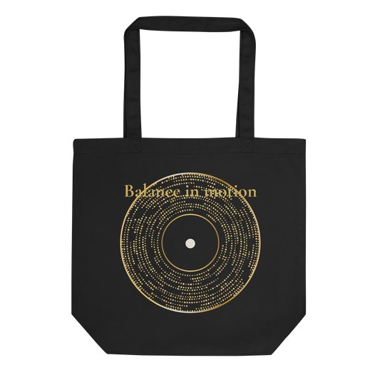 Black eco tote bag with a gold abstract circular graphic and minimalist typography.