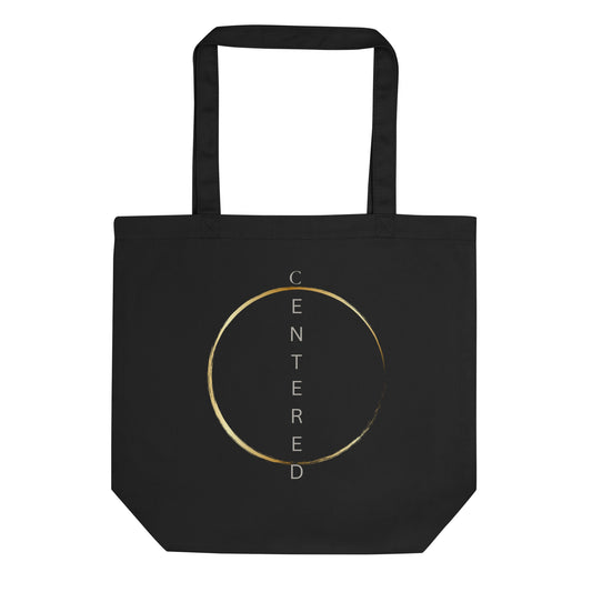 Black eco tote bag with a minimalist gold circle design, front view