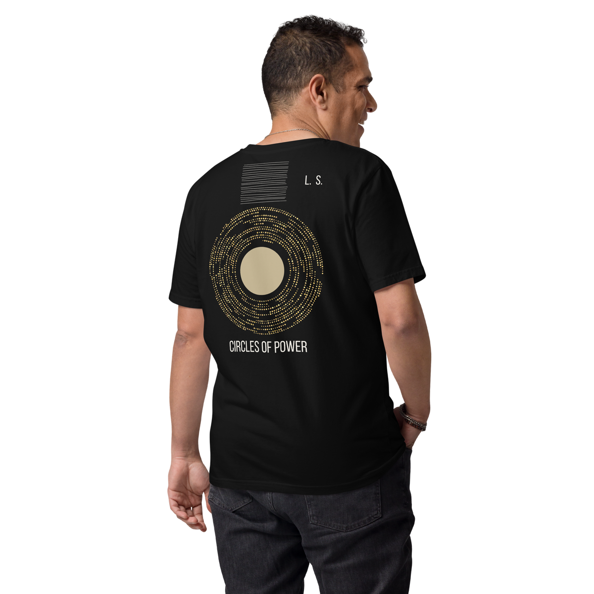 Person wearing a black unisex organic cotton T-shirt with a gold Circles of Power graphic on the back