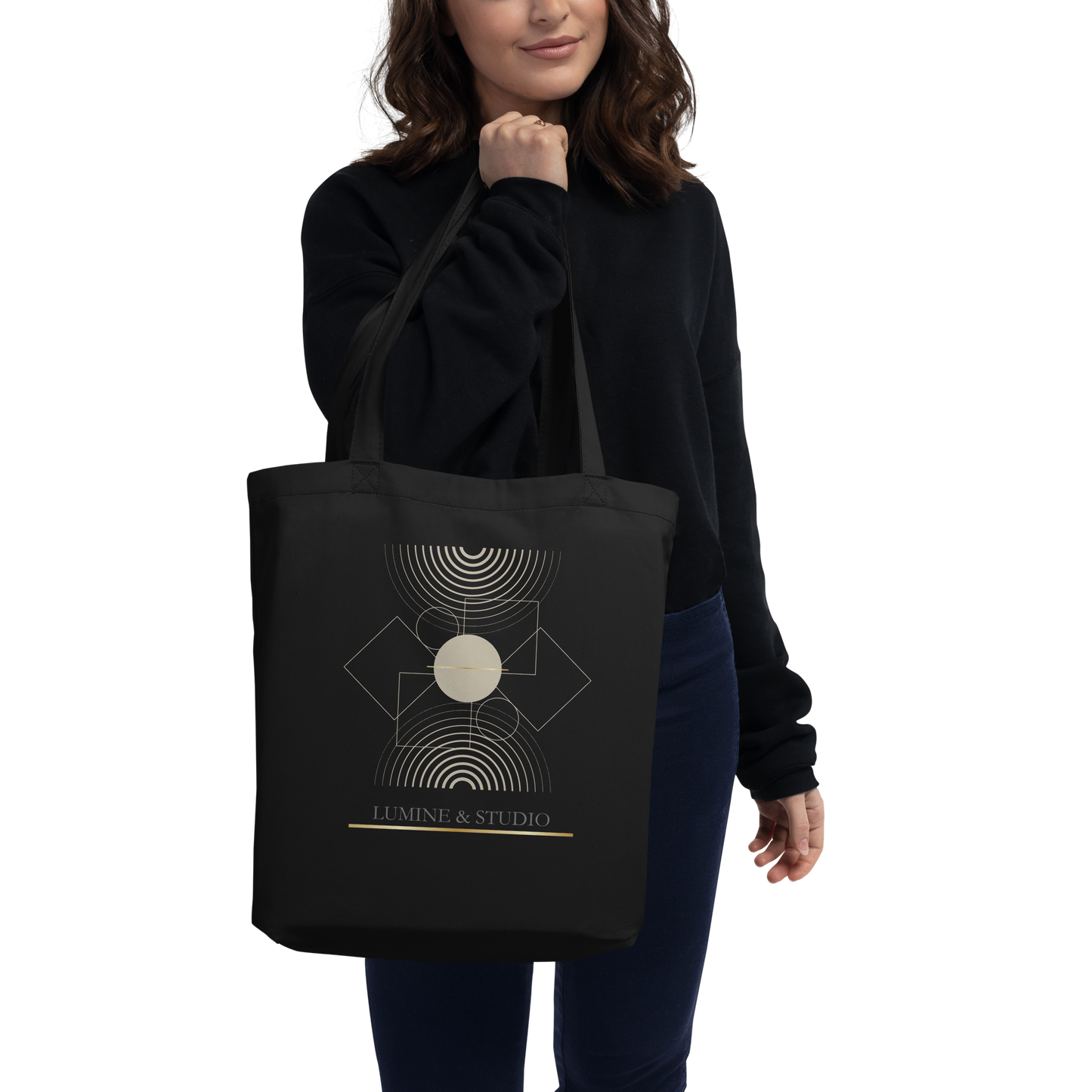 Person carrying the black Lumine Studio eco tote bag with minimalist geometric design