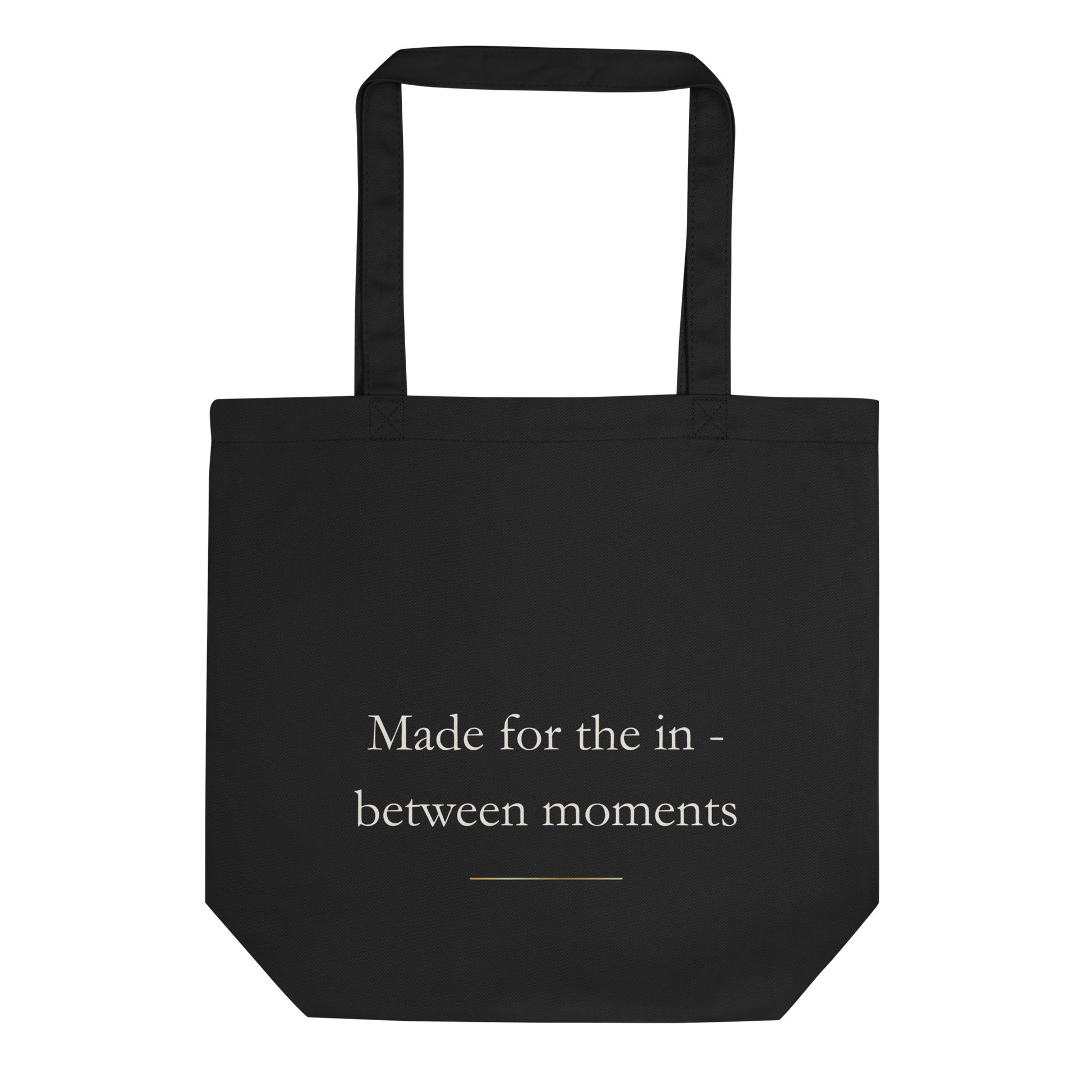 Back view of the black Lumine Studio eco tote bag with Made for the in between moments text