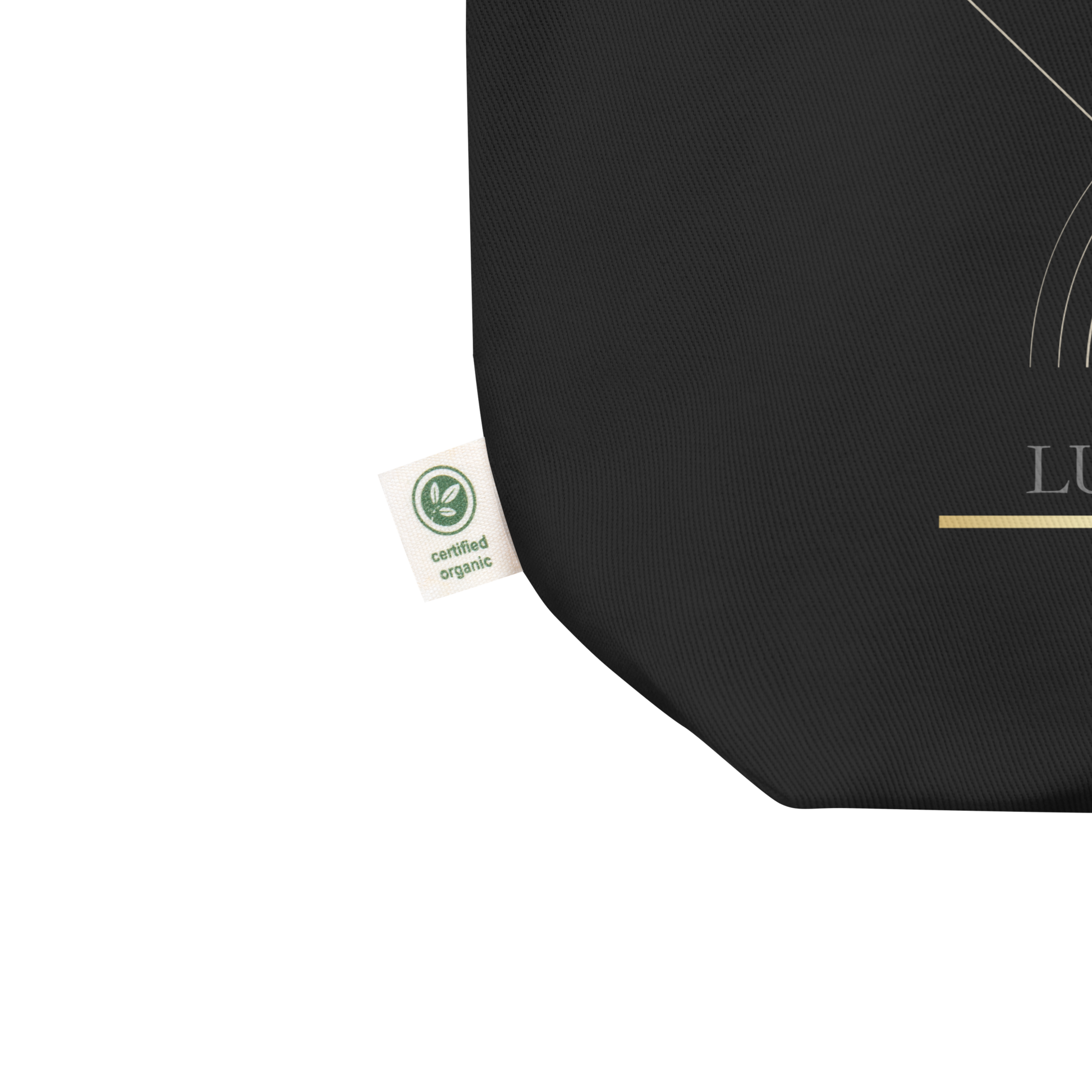 Close-up detail of the black Lumine Studio eco tote bag with organic certification label