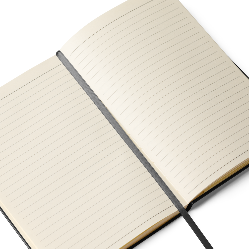 Open Lumine Studio black hardcover notebook showing lined pages and black ribbon bookmark