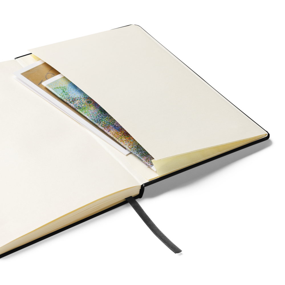 Open Lumine Studio black hardcover notebook showingthe inner storage pocket and ribbon bookmark