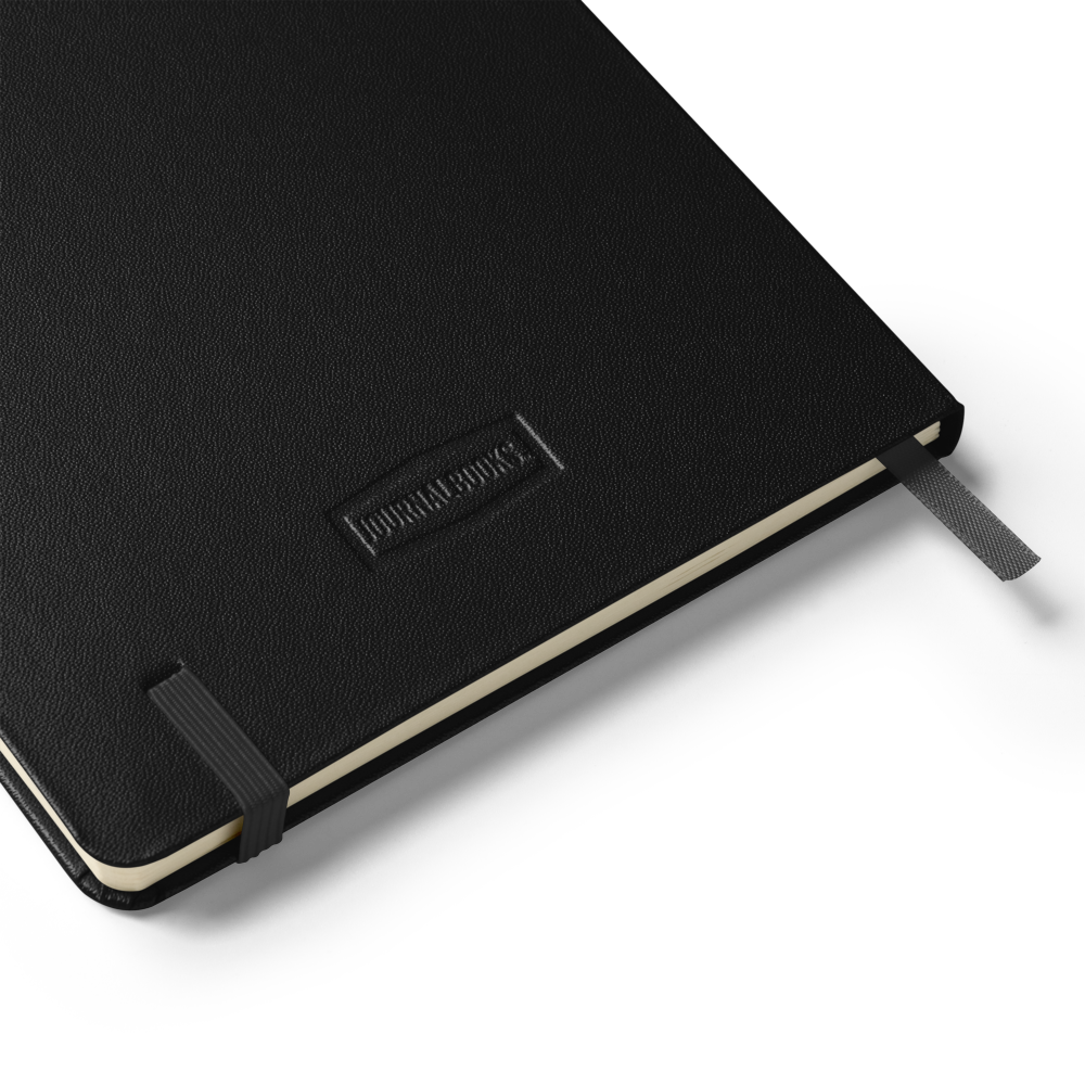 open Lumine Studio black hardcover notebook showing the inner storage pocket and ribbon bookmark