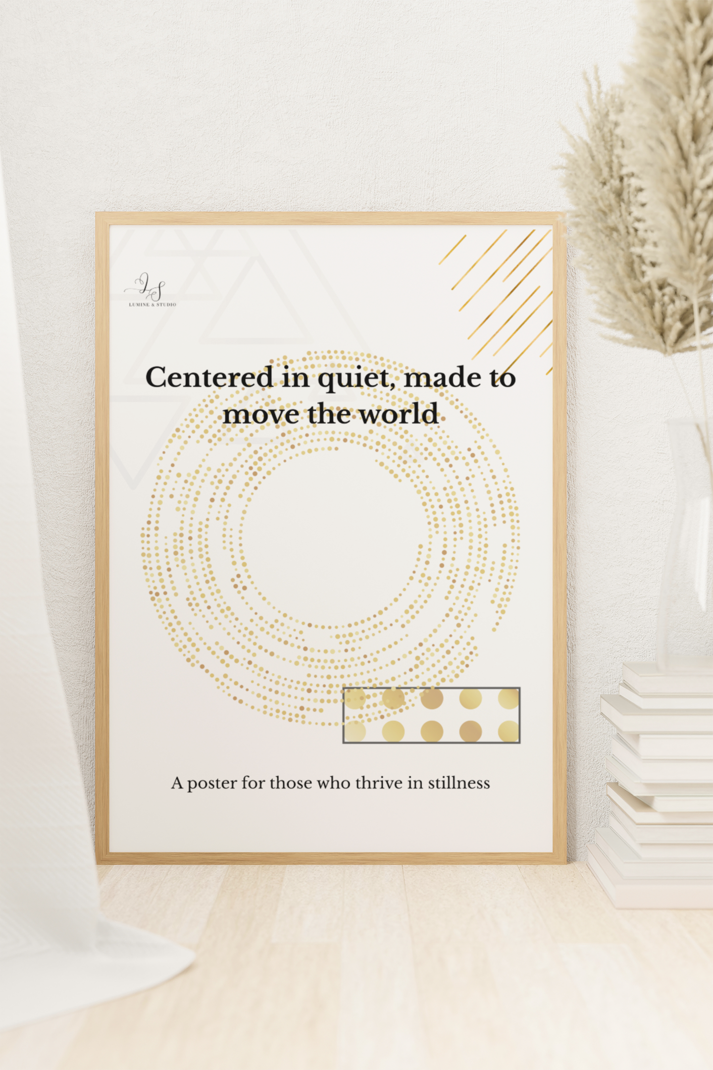 Minimalist geometric wall art displayed on the floor in a bright neutral interior