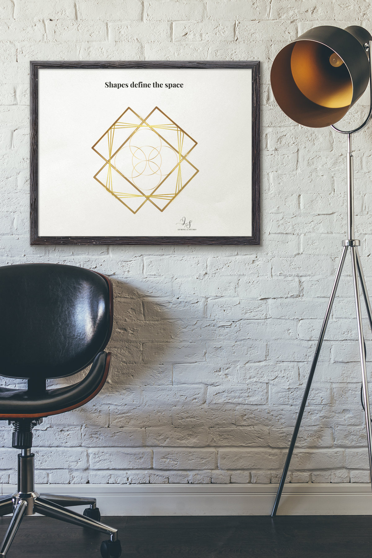 Minimalist geometric gold line wall art displayed on a white brick wall in a modern interior.