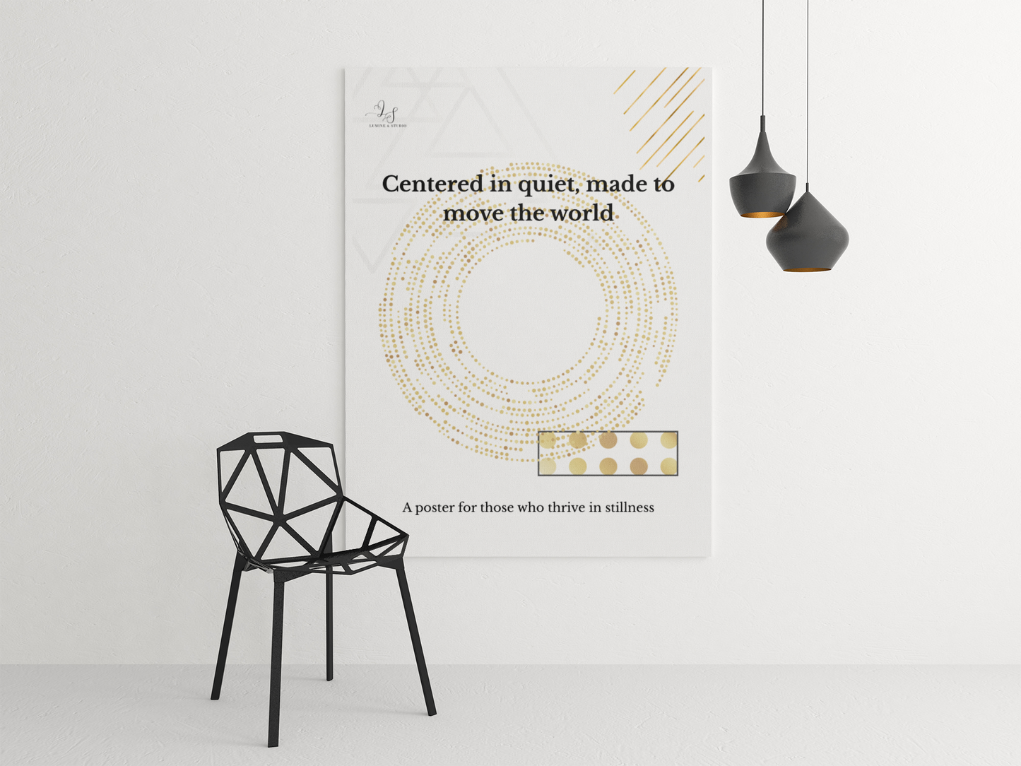 Minimalist geometric wall art displayed beside a modern black chair and pendant lights
