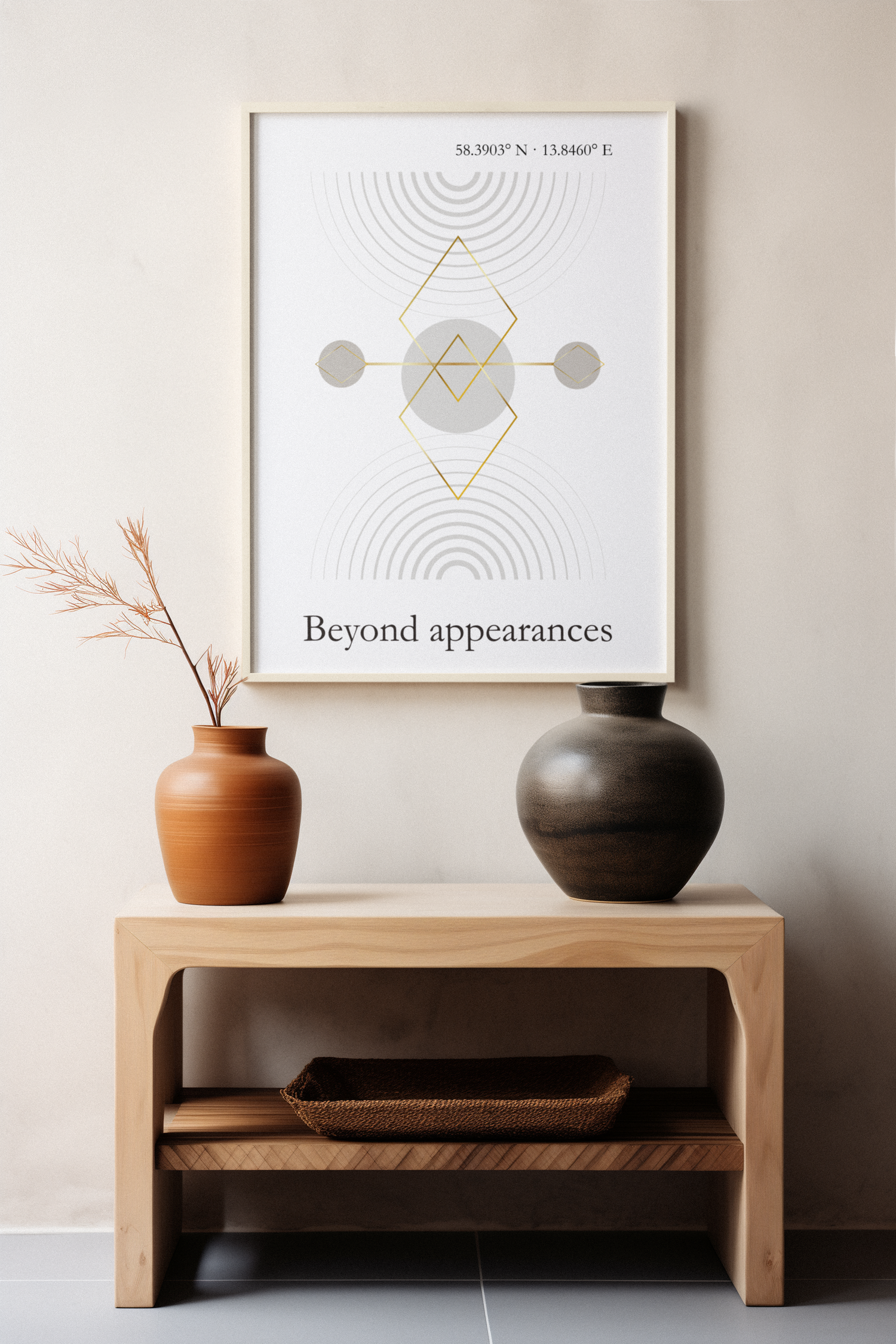 Minimalist geometric wall art print in neutral tones above a wooden table with ceramic vases