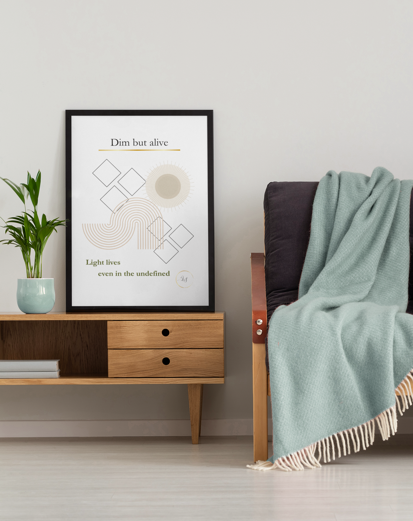 Minimalist geometric wall art displayed above a wooden console beside a neutral armchair
