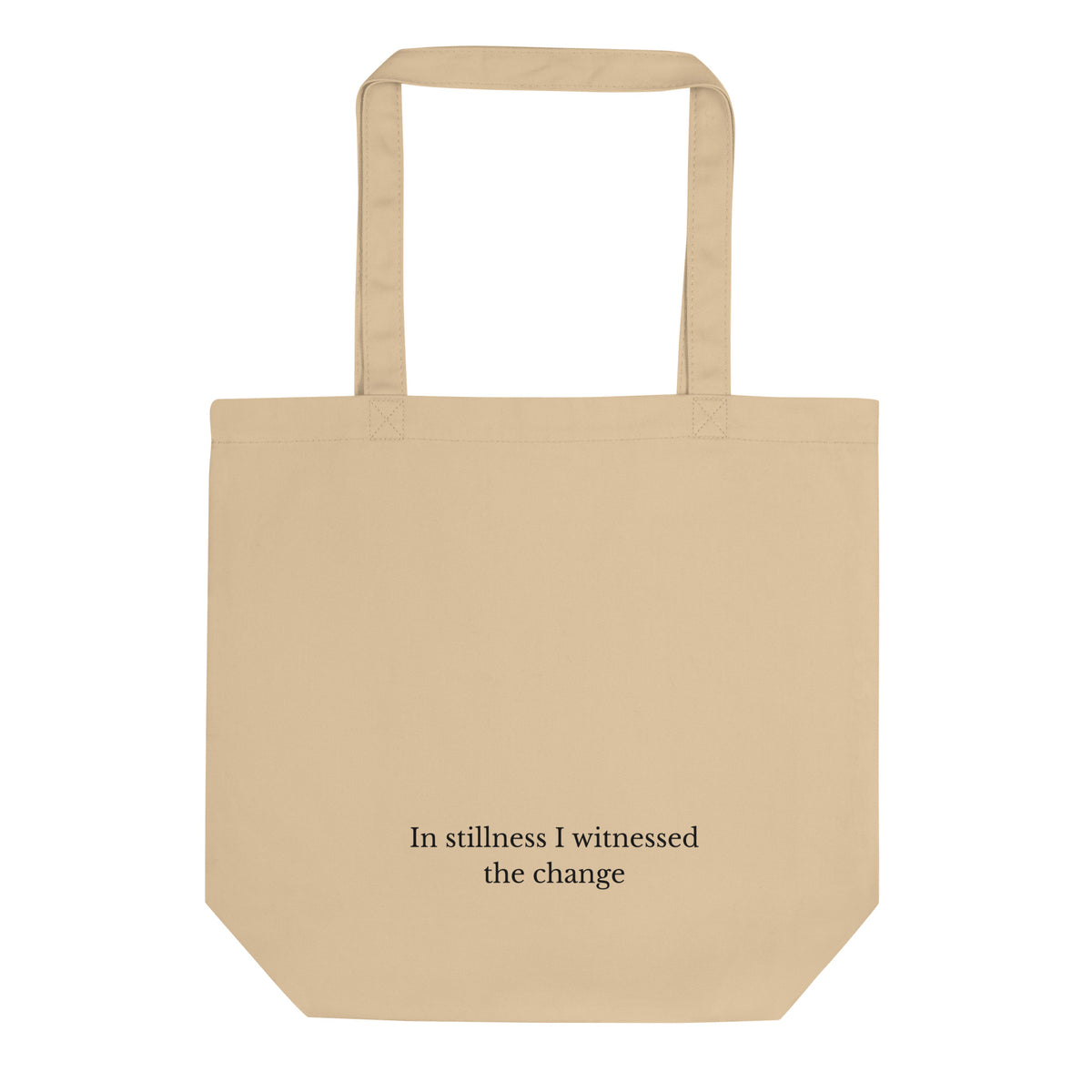 Oyster eco tote bag shown from the back ith minimalist typography reading "In stillness I witnessed the change".