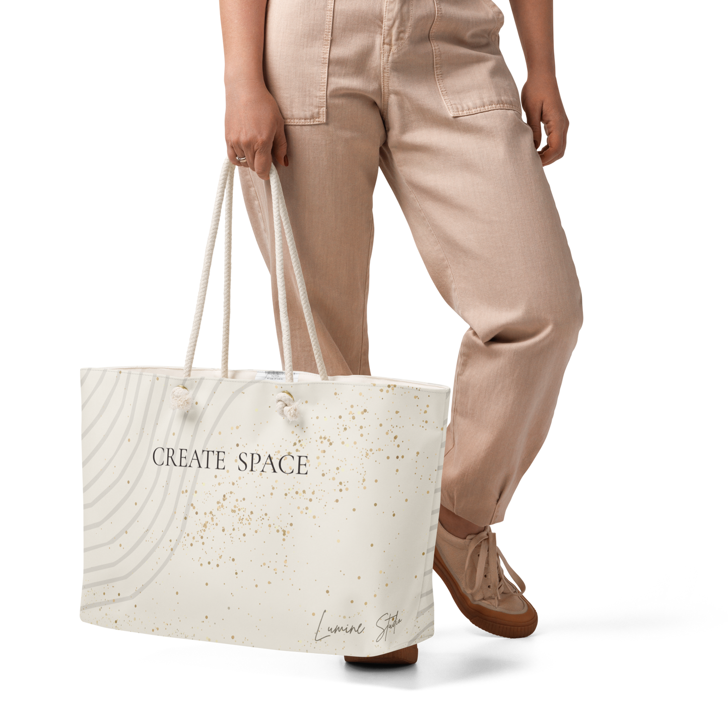 Woman carryng the Lumine Studio Create Space cream weekender bag
