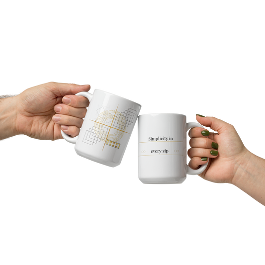 Two white 15 oz ceramic mugs held in hands, featuring minimalist geometric line art nd subtle gold details.