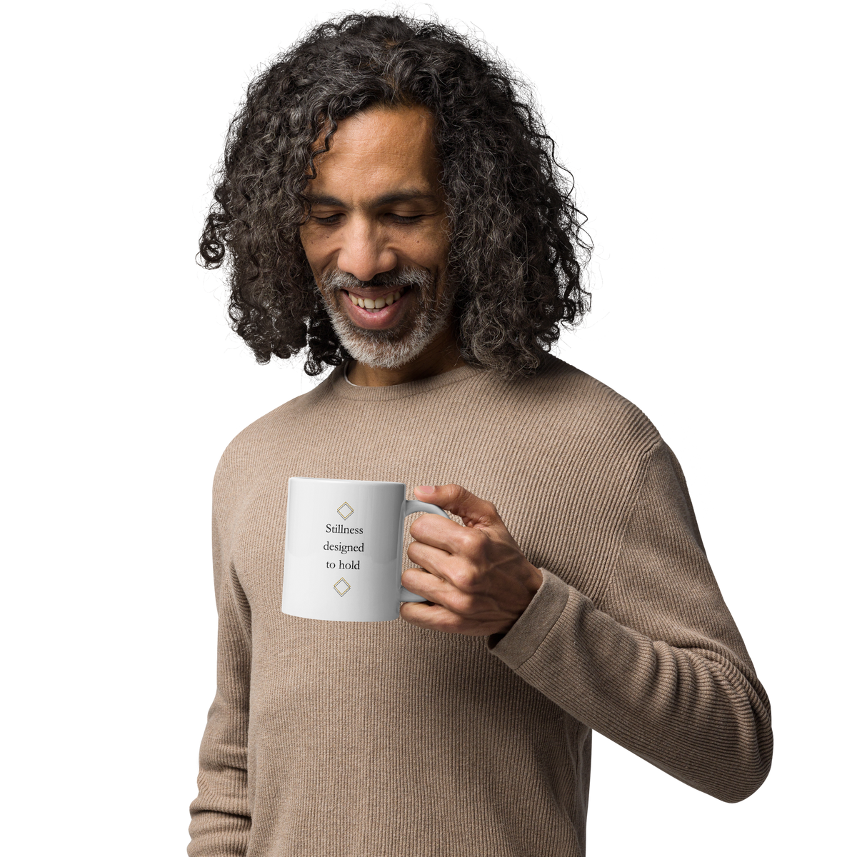 Man holding a white ceramic mug with minimalist typography, wearing a neutral sweater.