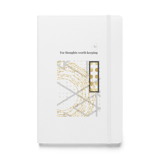 White hardcover notebook with abstract geometric line art, subtle gold details and minimalist typography.
