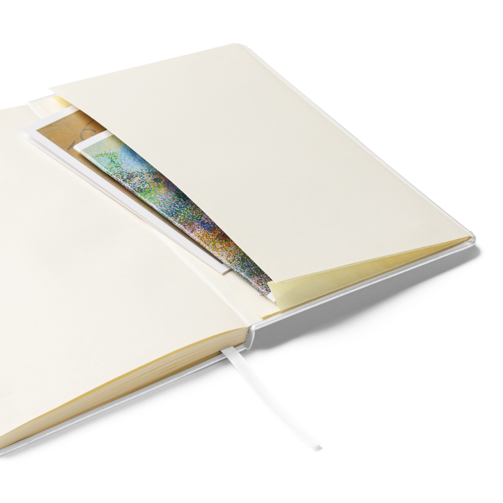 Open white hardcover notebook showing the inner storage pocket and white ribbon bookmark