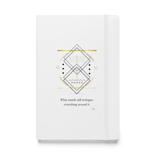 White hardcover notebook with minimalist geometric line art and small typography on the cover.