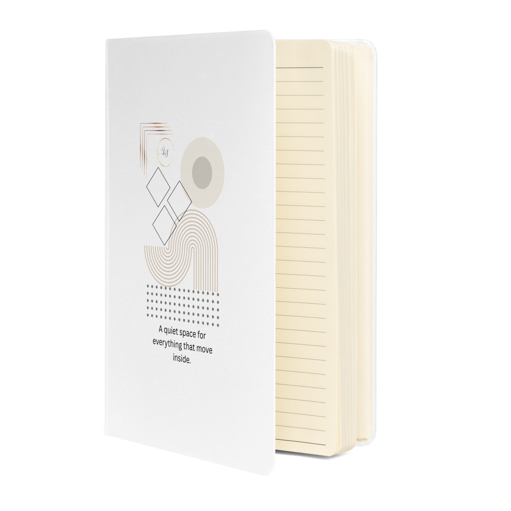 White hardcover notebook with minimalist geometric design shown partially open with lined pages
