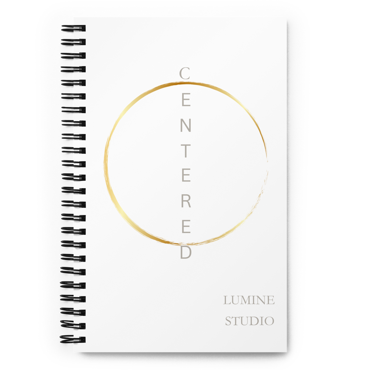 White spiral notebook with a minimalist gold circle design, front