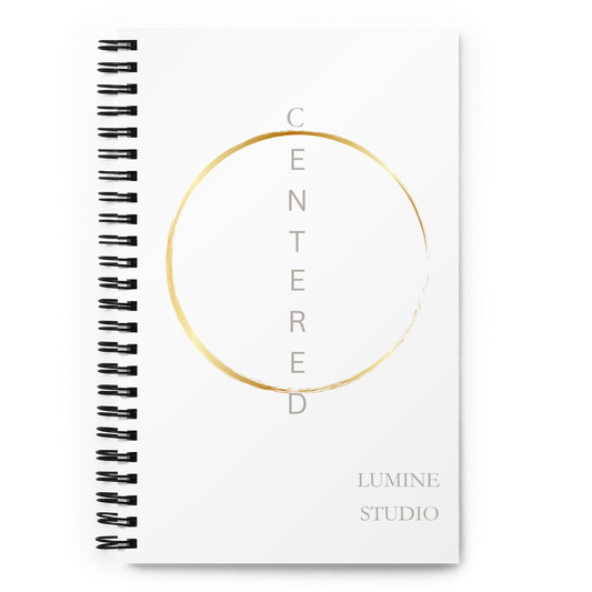 White spiral notebook with a minimalist gold circle design, front